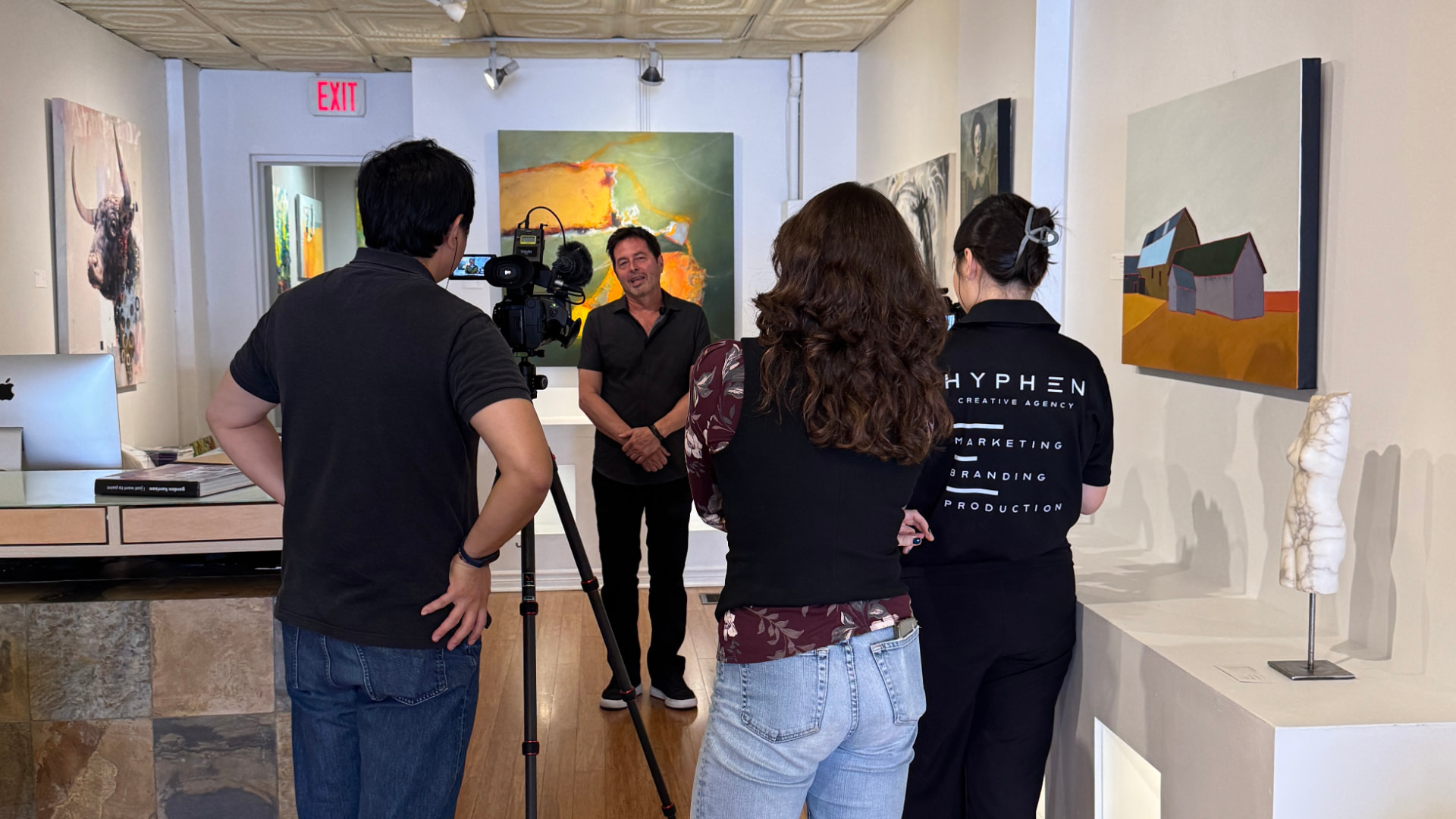 Hyphen Creative crew filming an interview in a Toronto art gallery for the Amazing Korean segment