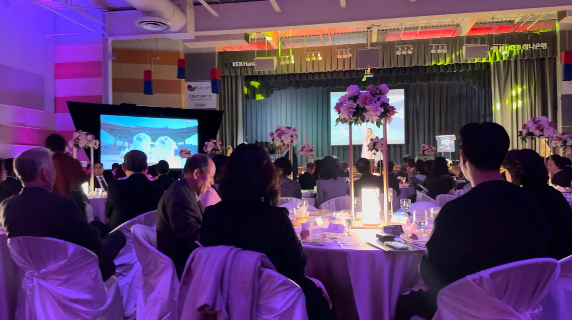 Guests seated at the Korean Society of Toronto 60th Anniversary Gala with the main stage and screens